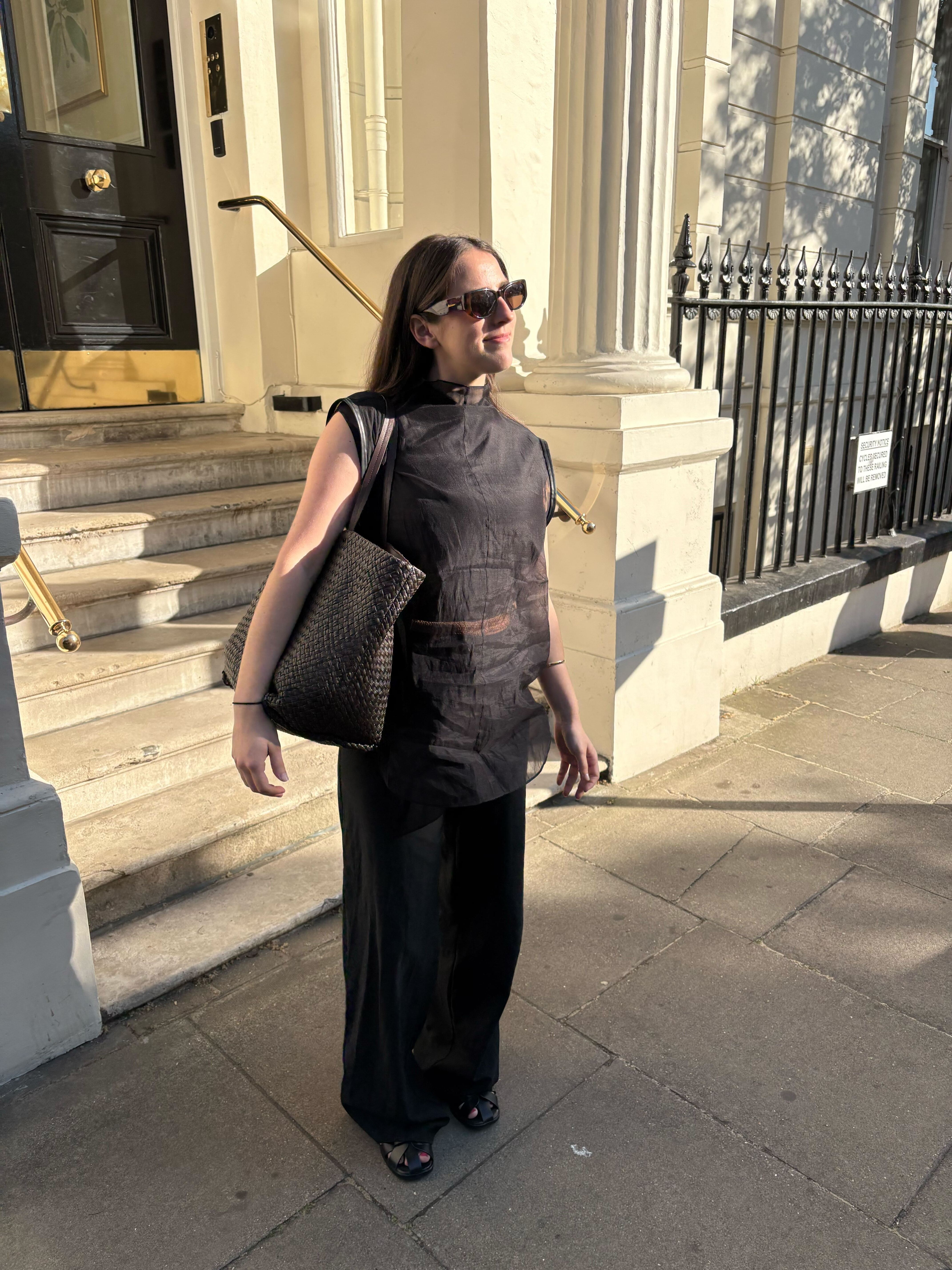 An image of @avahgilchrist wearing one of the key sleeveless top trends.