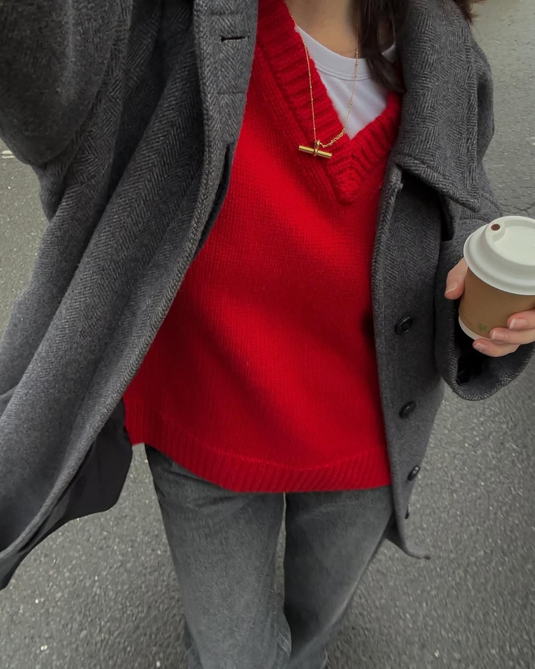 @francescasaffari wearing a red jumper and grey jeans