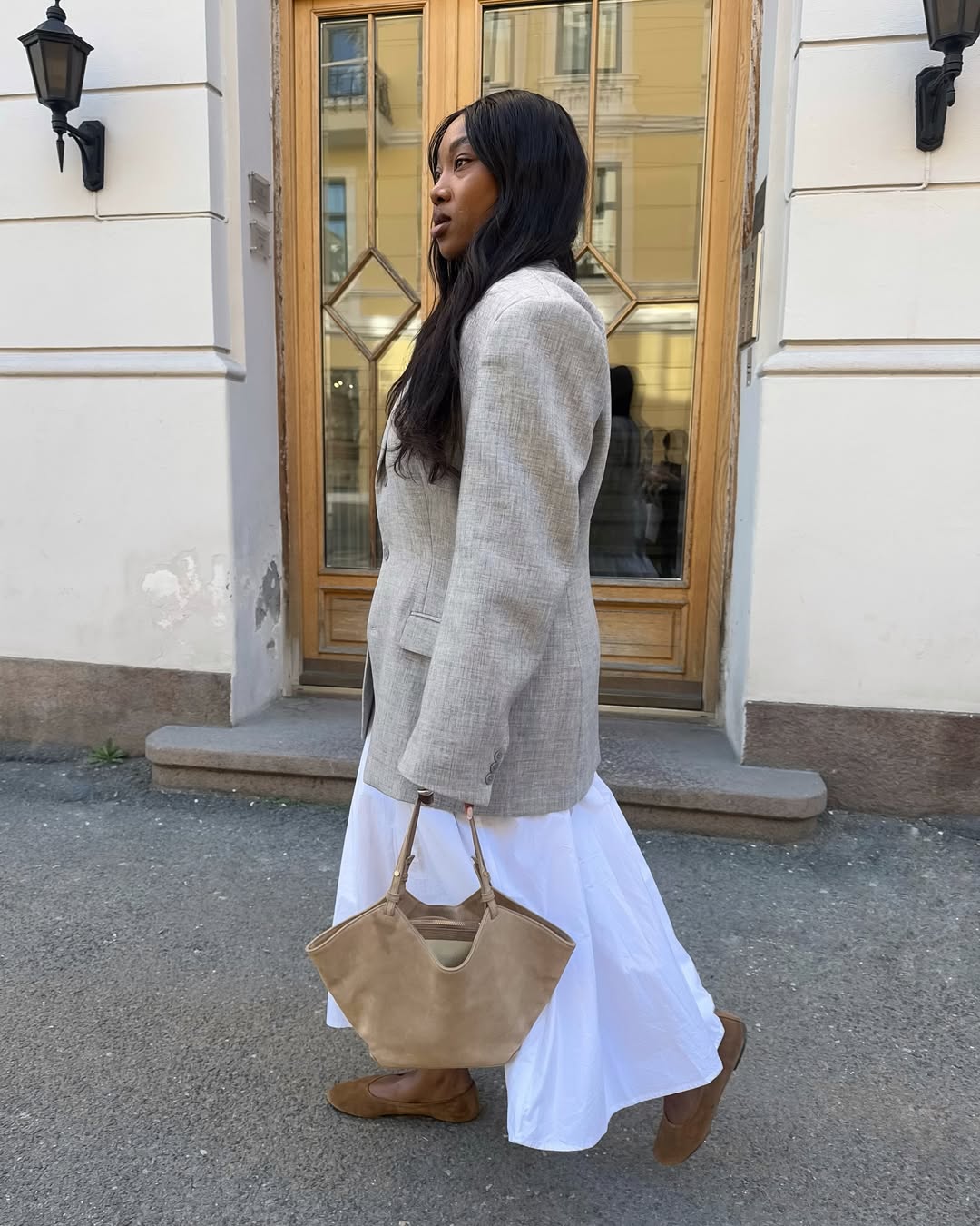 @nnennaechem wearing a blazer, skirt and ballet pumps