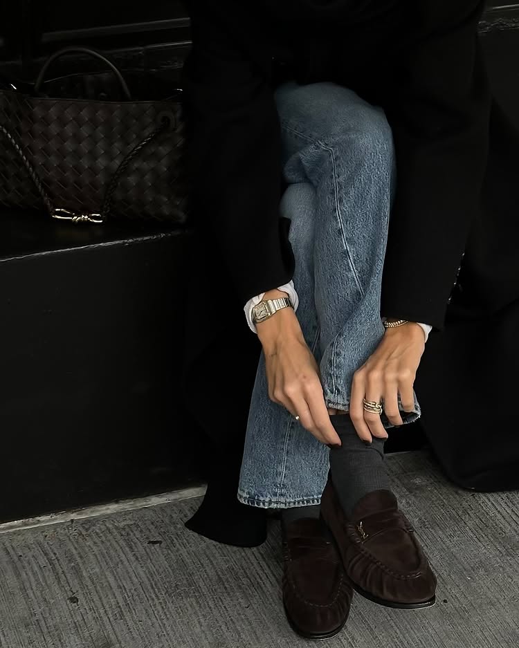 @hannahlewisstylist wears brown Saint Laurent loafers, grey socks and blue straight-leg jeans