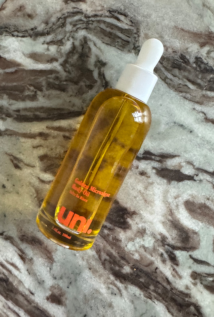 Uni body oil on a marble table