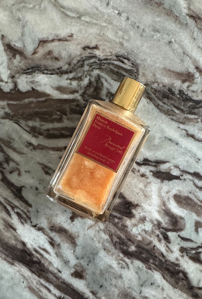 Maison Francis Kurkdjian Baccarat Rouge 540 sparkling body oil on a marble table