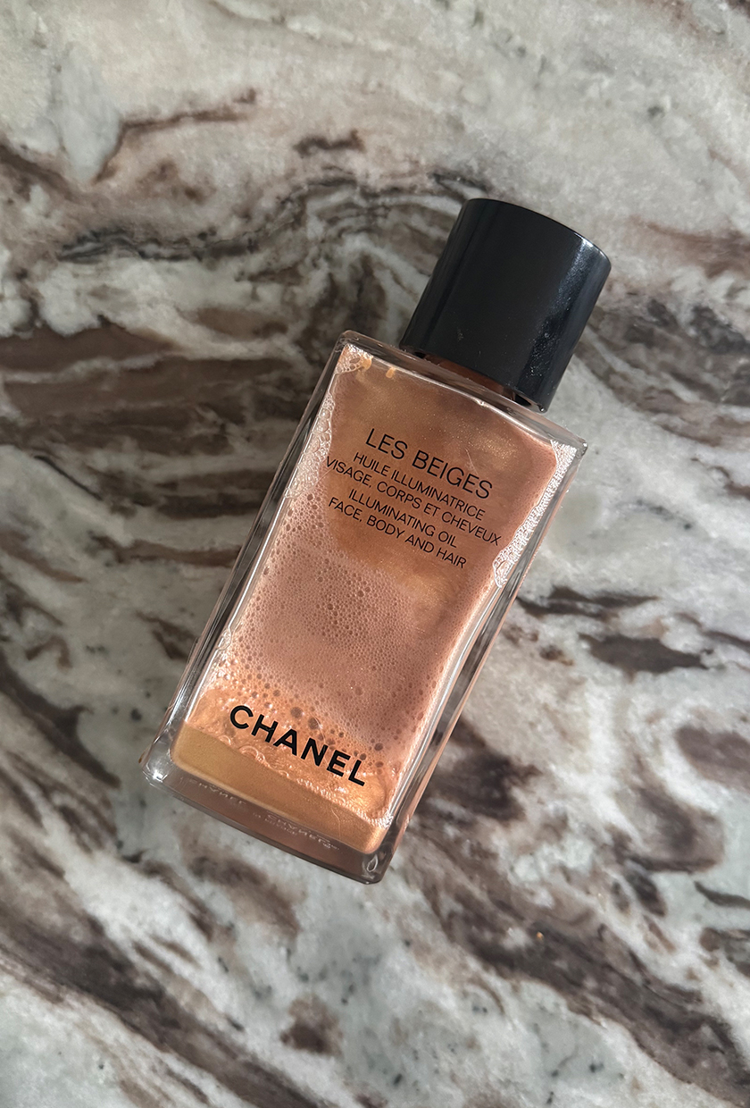 Chanel Les Beiges shimmer body oil on a marble table