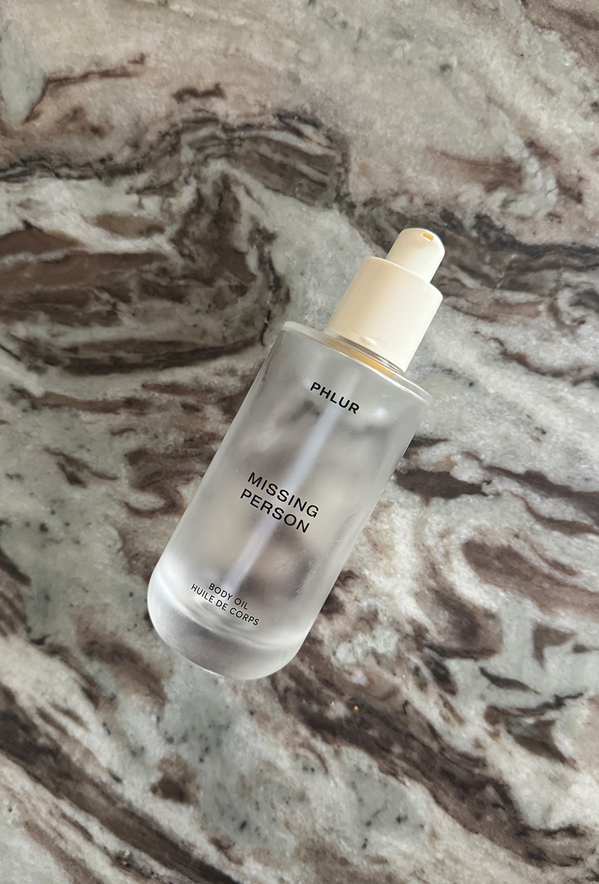 Phlur Missing Person body oil on a marble table