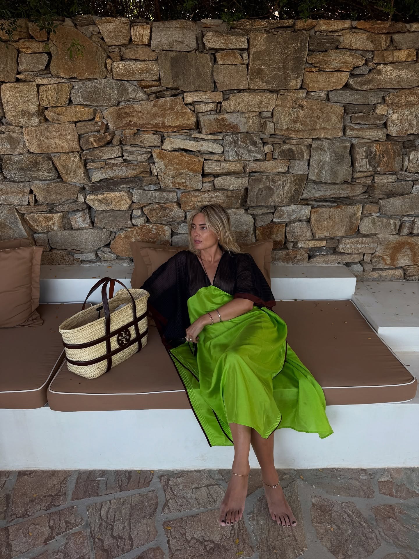 Influencer @lucywilliams02 wears a dill green dress with a wicker bag.