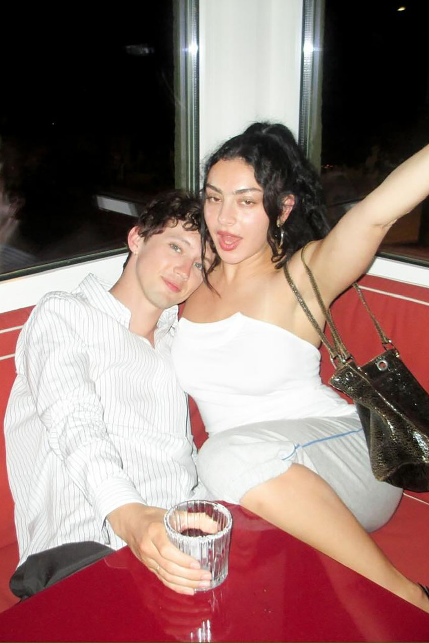 Charlie XCX wearing a white T-shirt tube top.