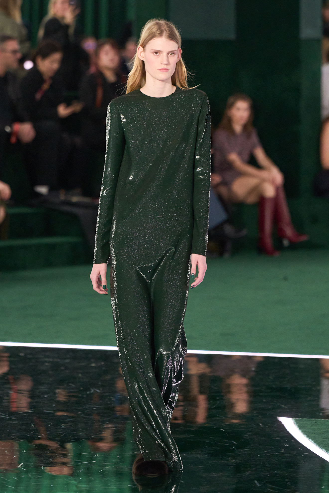 A Gucci model walking at the F/W 25 show during Milan Fashion Week wearing a hunter green long-sleeve sequin gown.