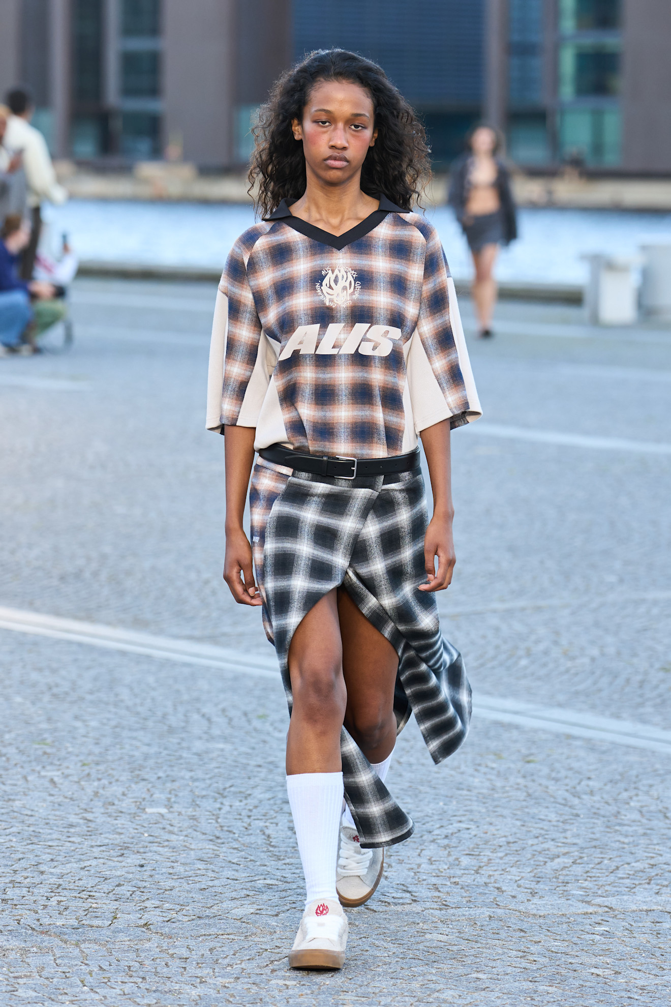 Model wears a check tartan print on the Alis spring summer 2026 runway