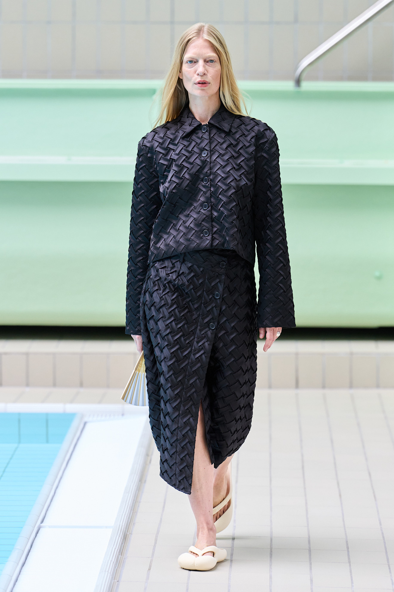 Model wears a woven garment on the Operasport spring summer 2026 runway.