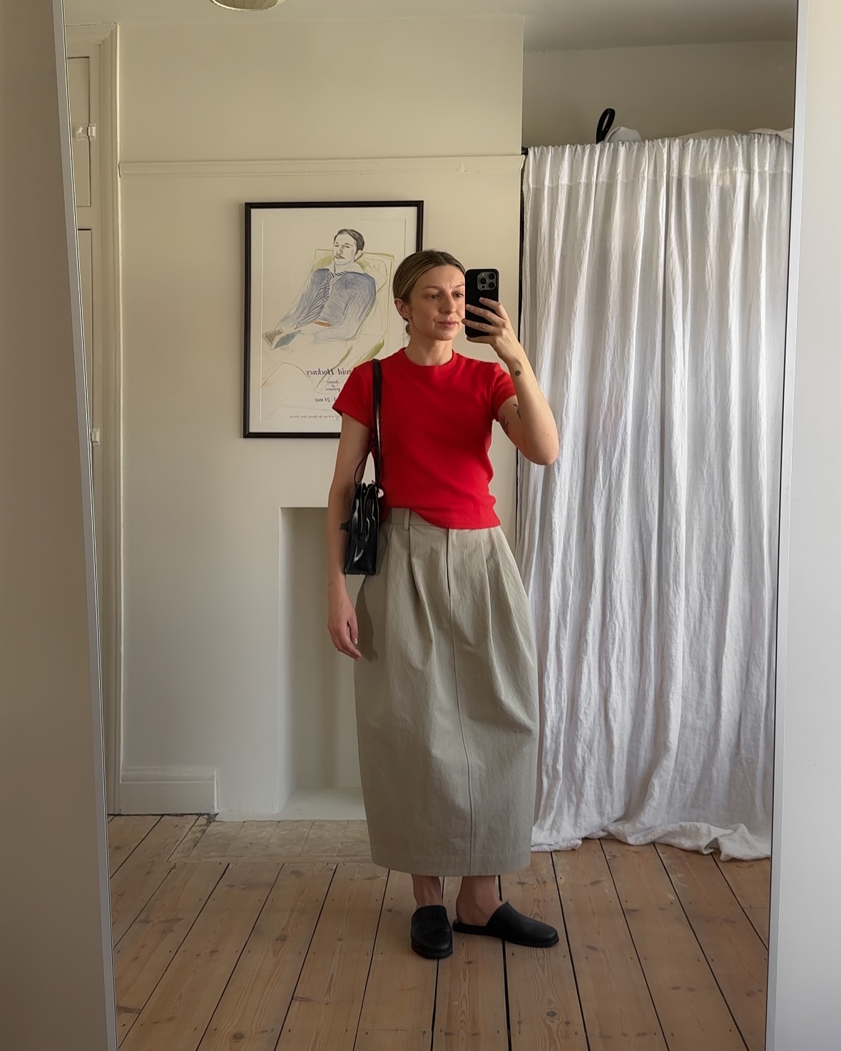 An image of @brittanybathgate wearing leather slippers with a red top.