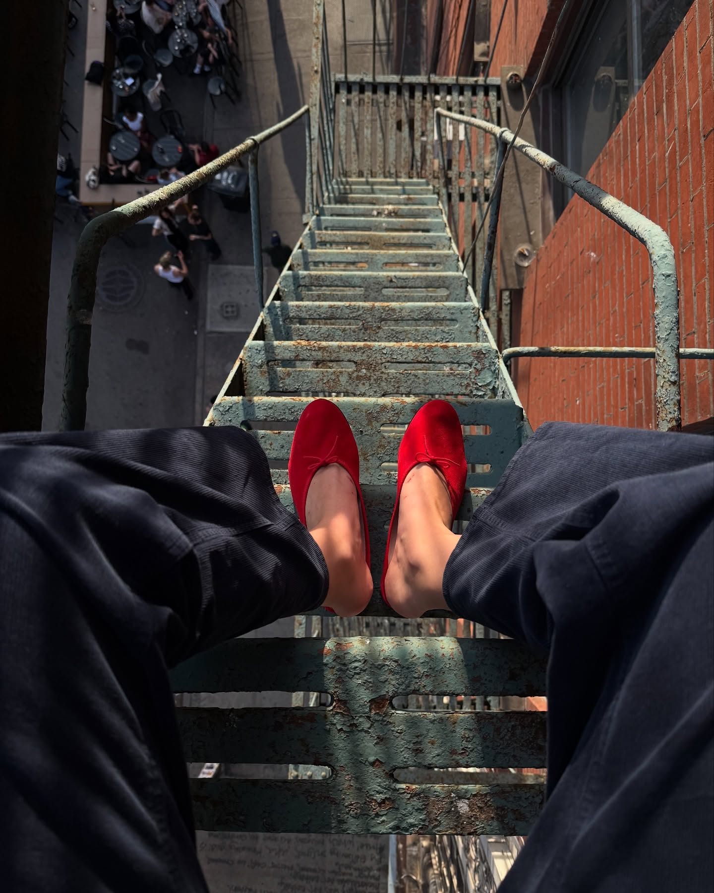 An image of @lizzyhadfield wearing red slippers.