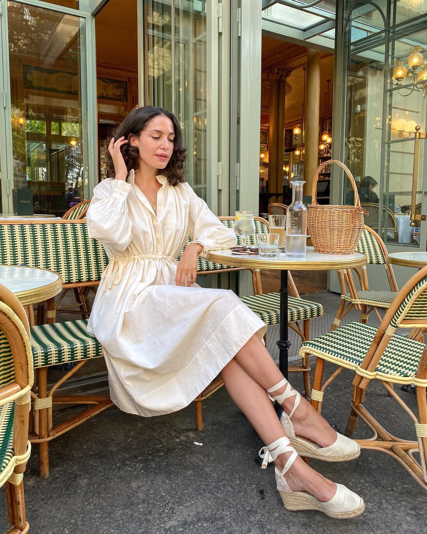 Influencer @melodiebanfield wears a white cotton dress with white espadrille wedges.