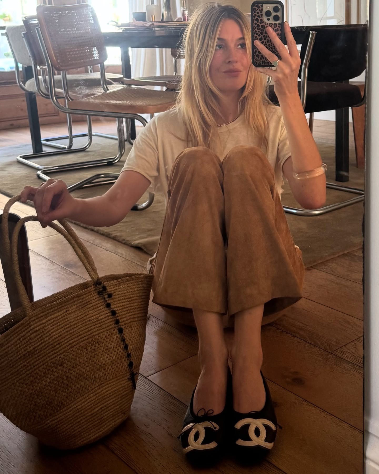 A woman taking a mirror selfie with smudged blonde hair