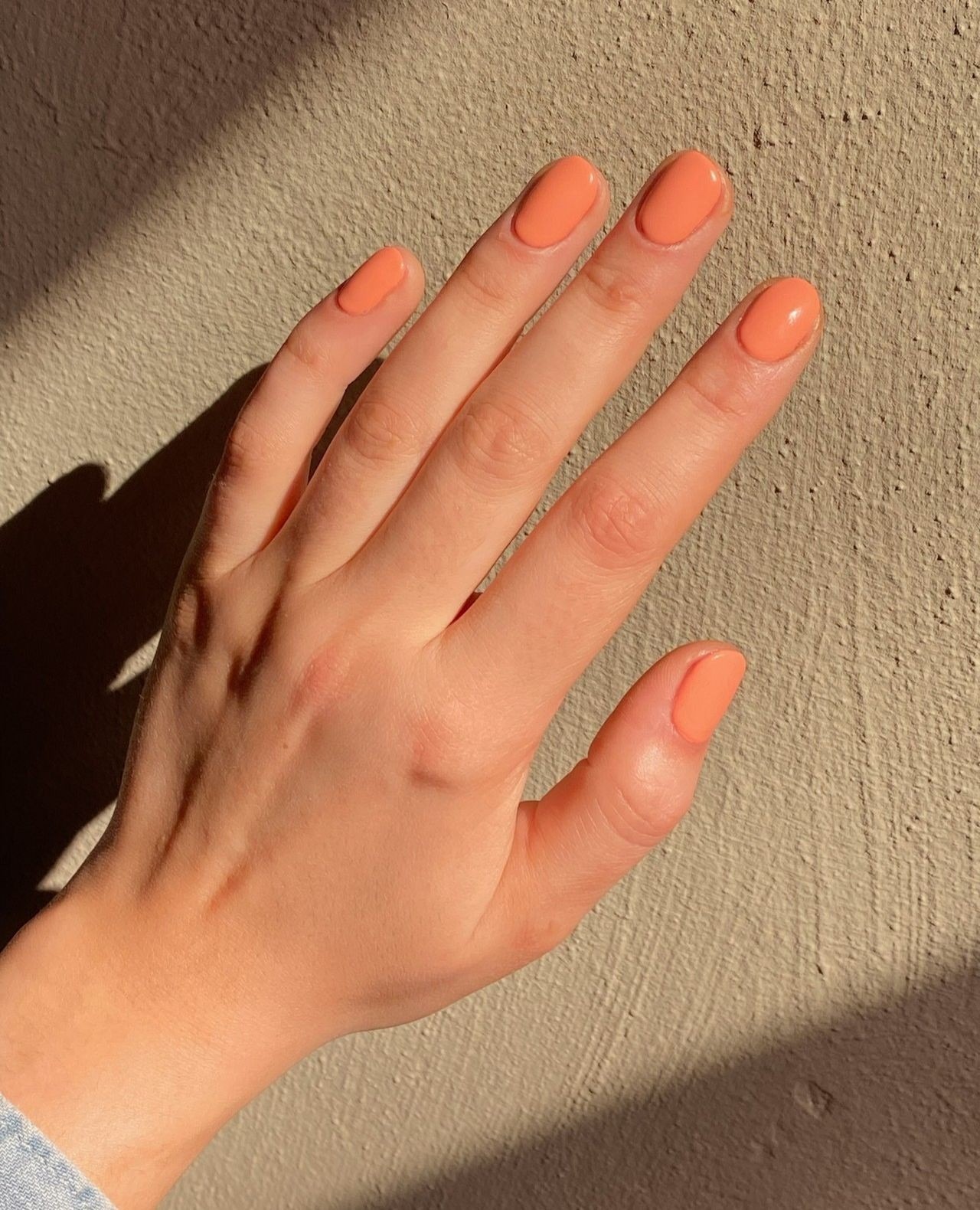 Photo of @buffcs wearing apricot nail polish