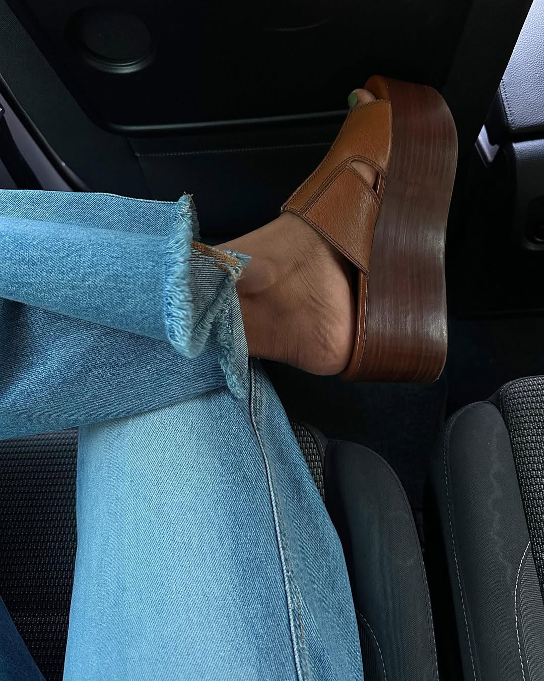 Influencer Monikh wears wooden platform clogs with a leather upper.