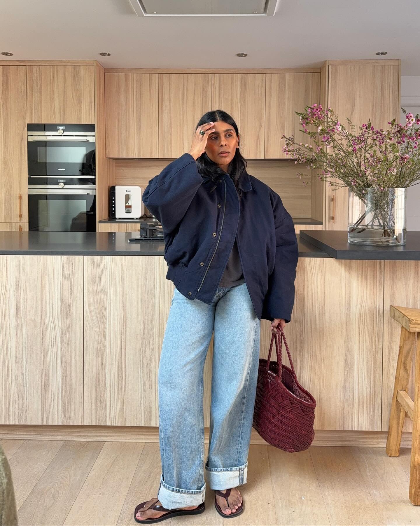 Monikh wears a navy cotton canvas jacket.