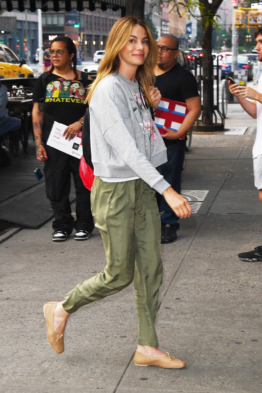 Michelle Monaghan wearing a gray sweatshirt, olive green pants, and tan woven flats in NYC