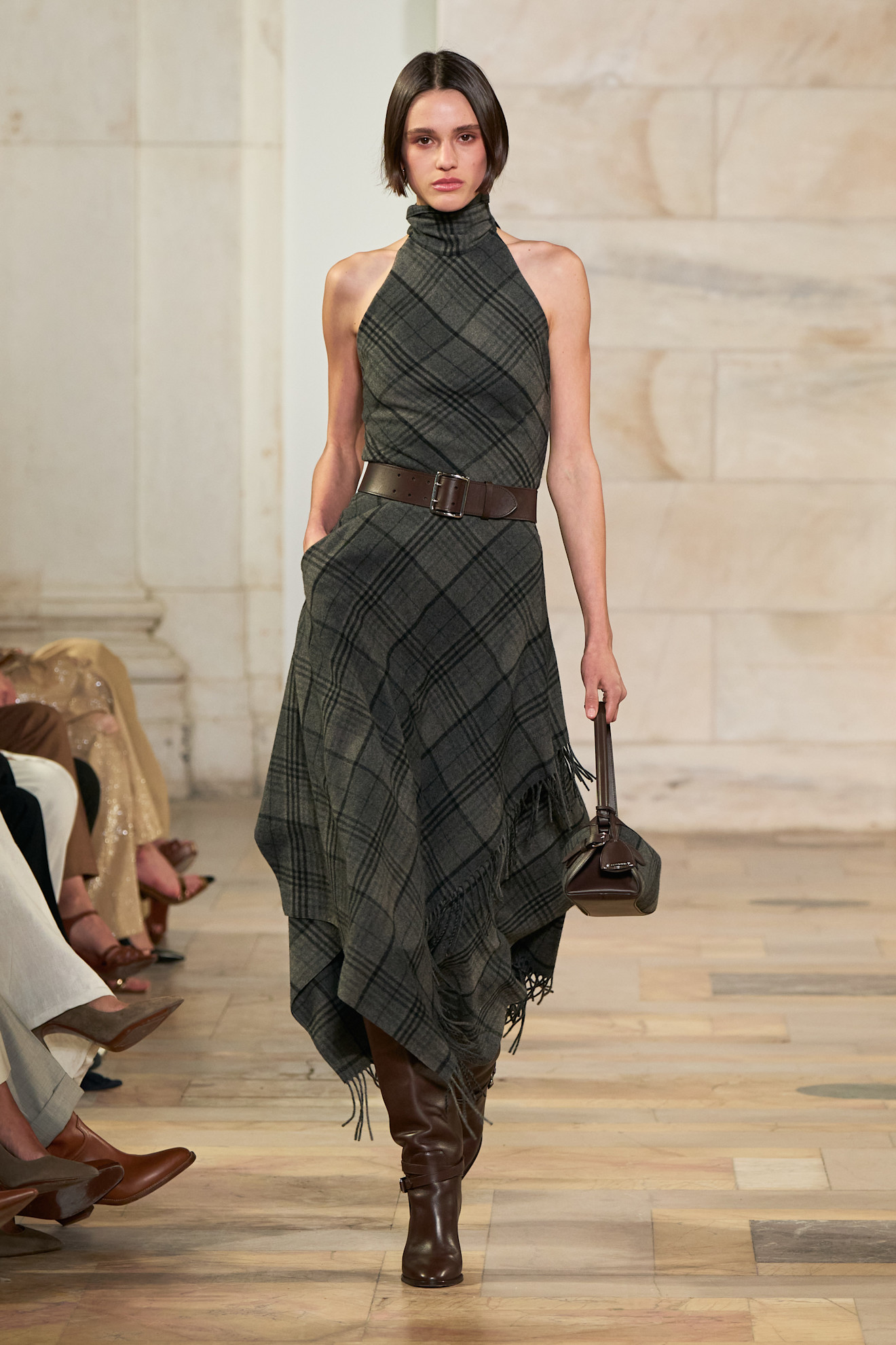 Ralph Lauren model walking the fall/winter 2025 runway wearing a plaid dress.