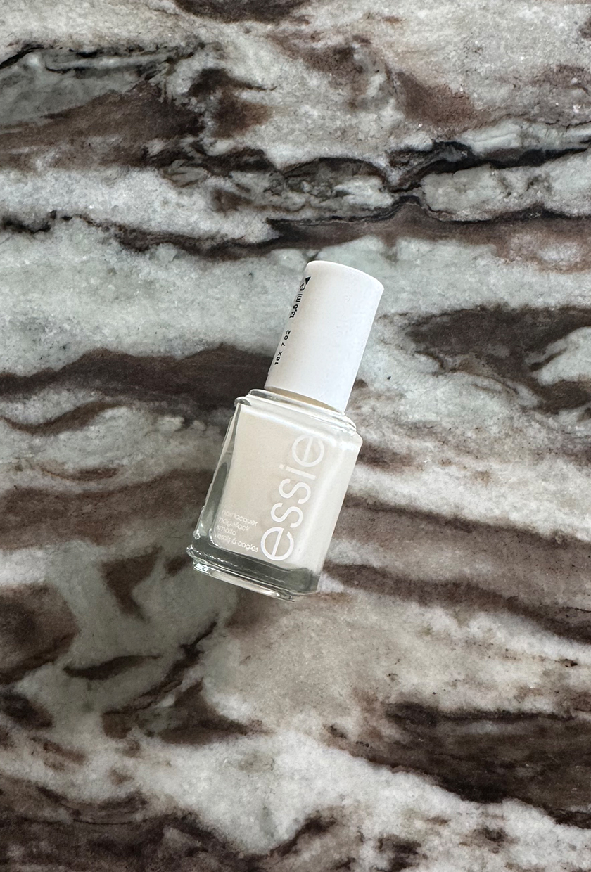 Essie Allure Nail Polish bottle on a marble table