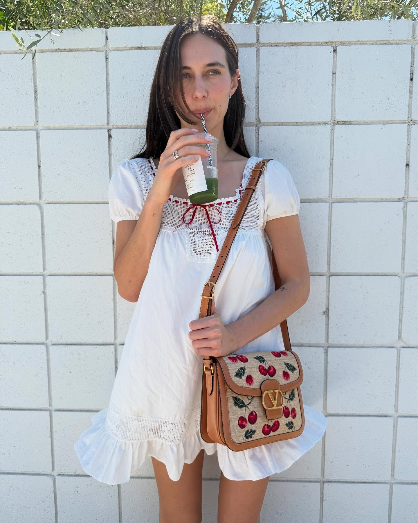 Devon Lee Carlson wears the Frankies Bikinis X Bella Hadid collab swing mini dress in a recent image from her Instagram.