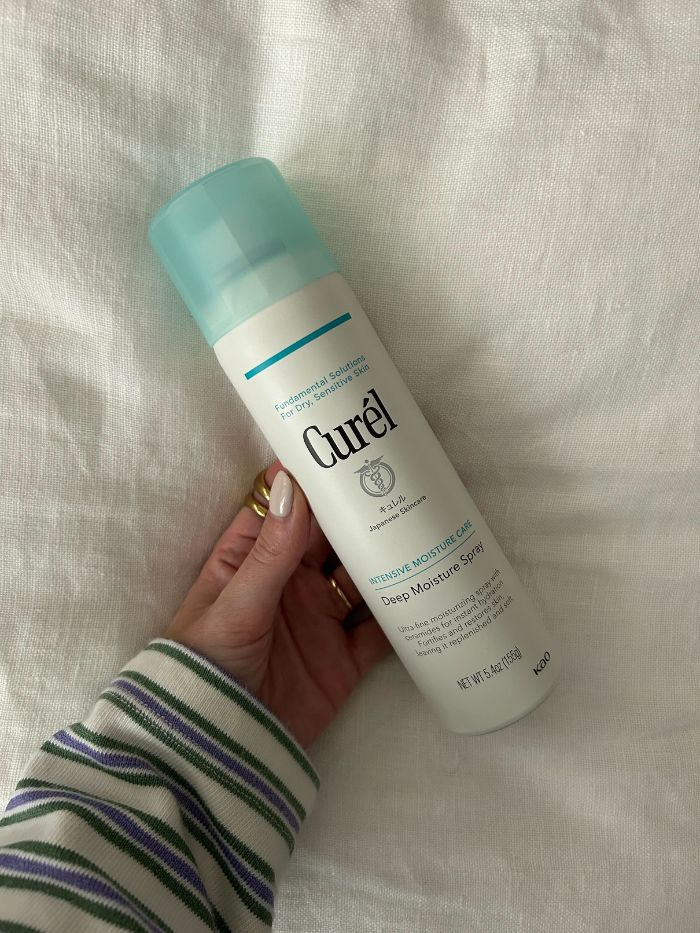 Junior beauty editor, Grace Lindsay, holding the Curel Deep Moisture Spray