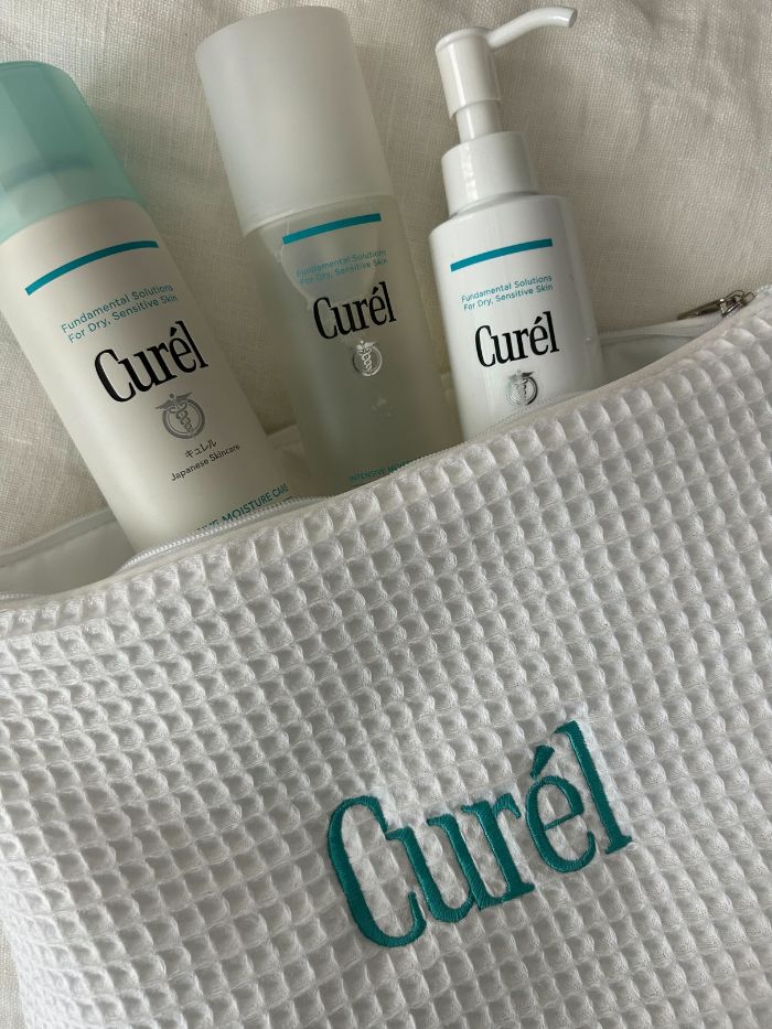 Curel skincare products on a white linen background