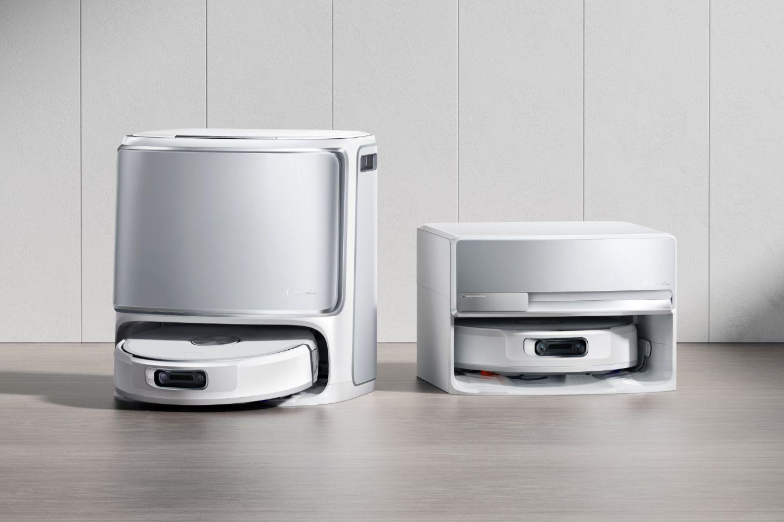 Two Narwal Flow robovacs, one with a taller base.
