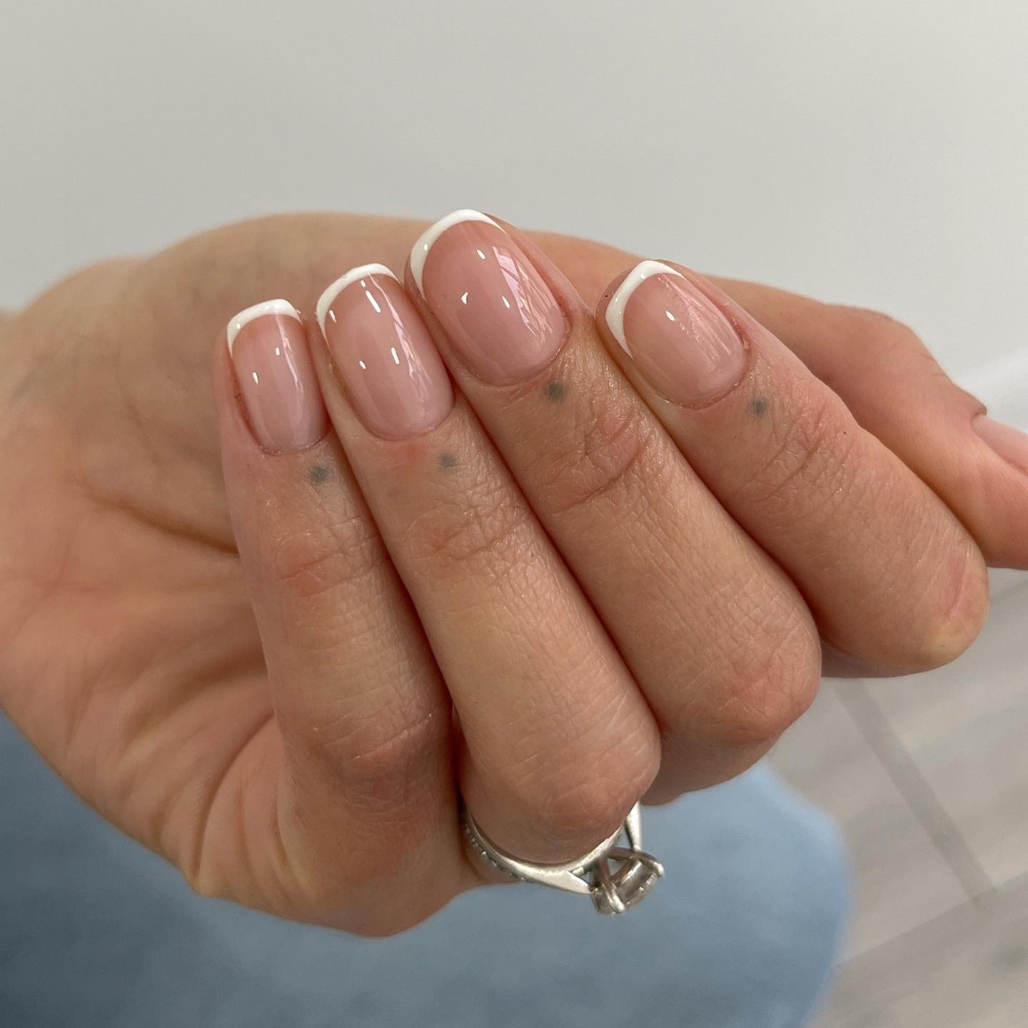 A short, square glass French mani