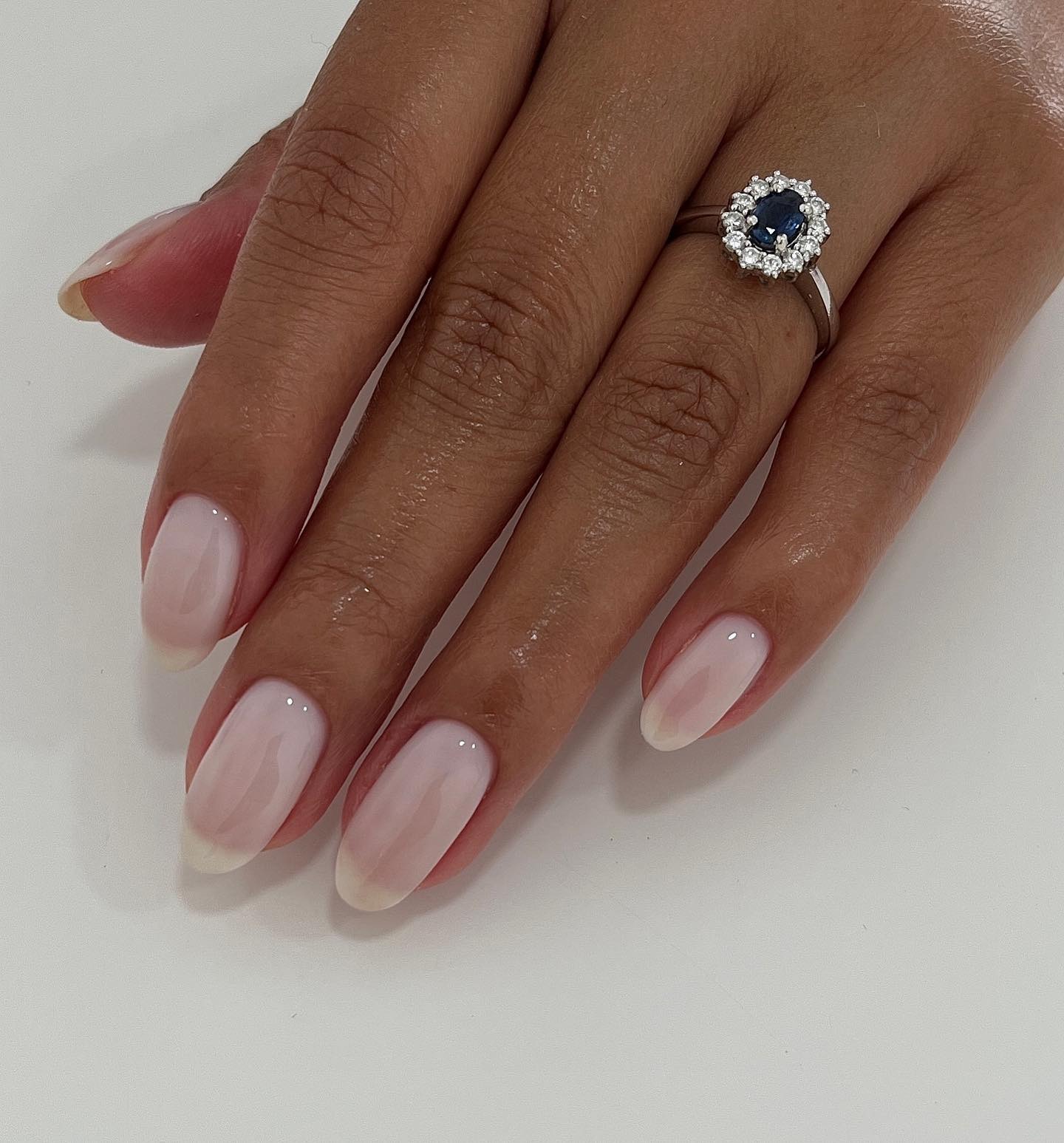 Long, almond nails with a milky base and a shimmery finish