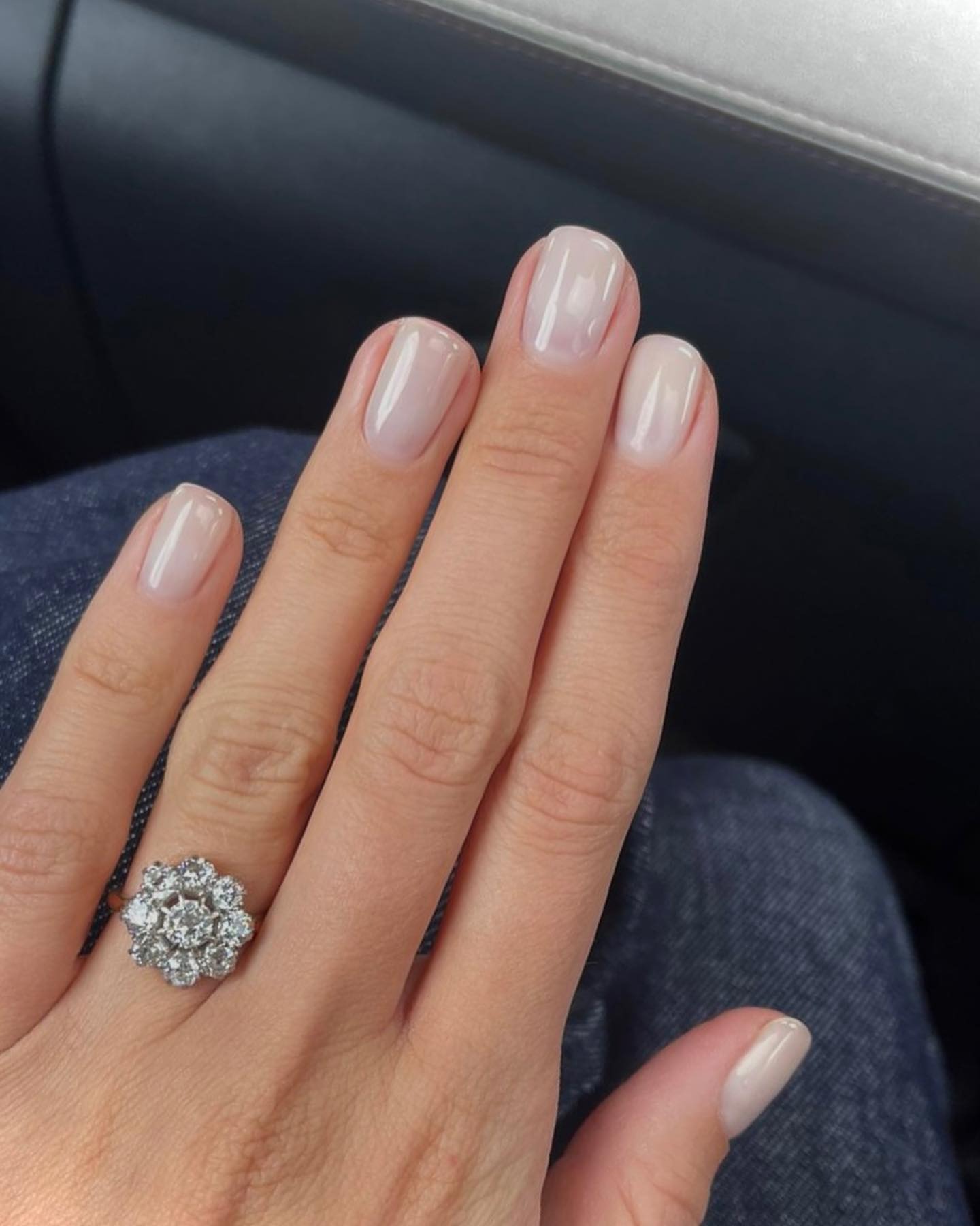 A short, milky manicure with a shimmery finish