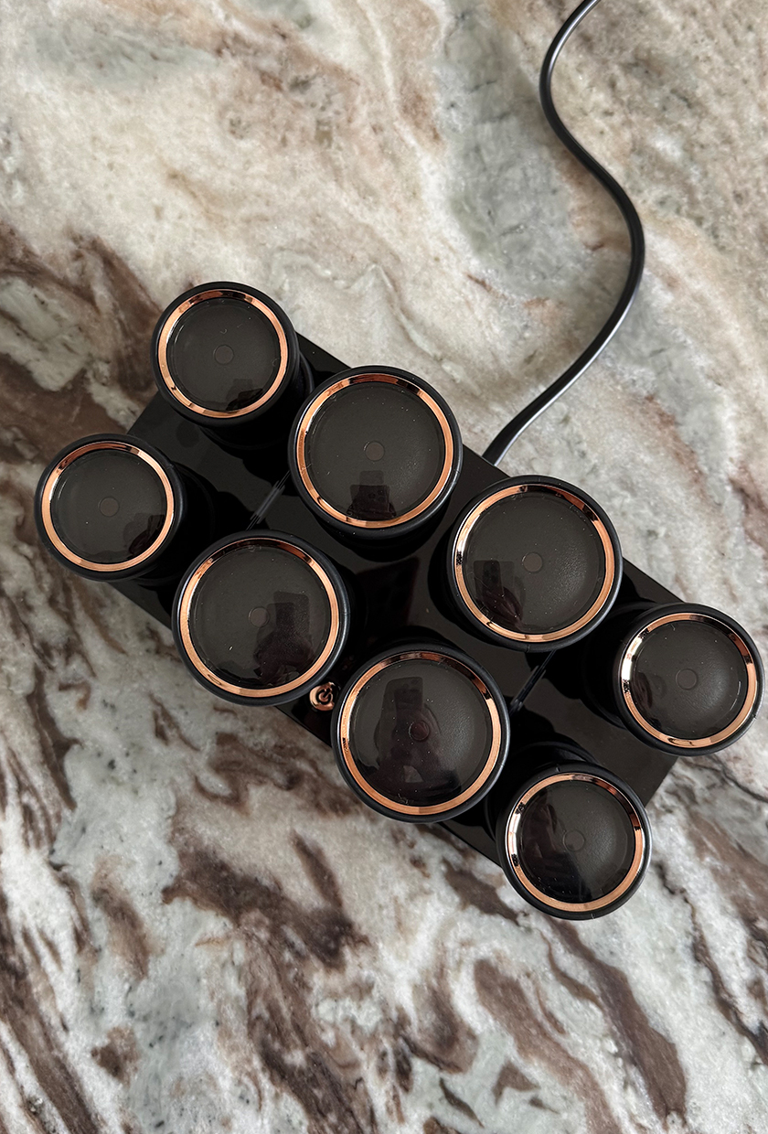 A close up of the T3 hair rollers on a marble surface