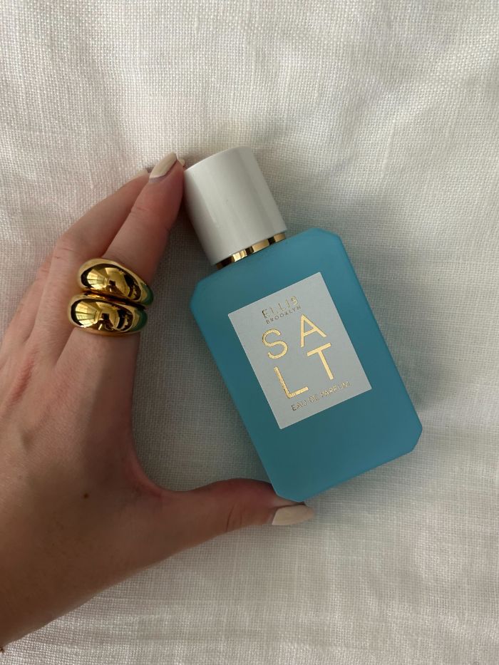 Junior beauty editor, Grace Lindsay, holding the Ellis Brooklyn Salt Eau de Parfum