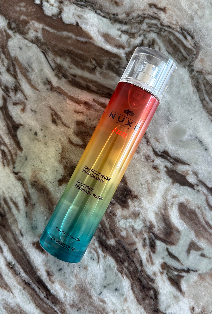Nuxe Sun Fragrance Water on marble table