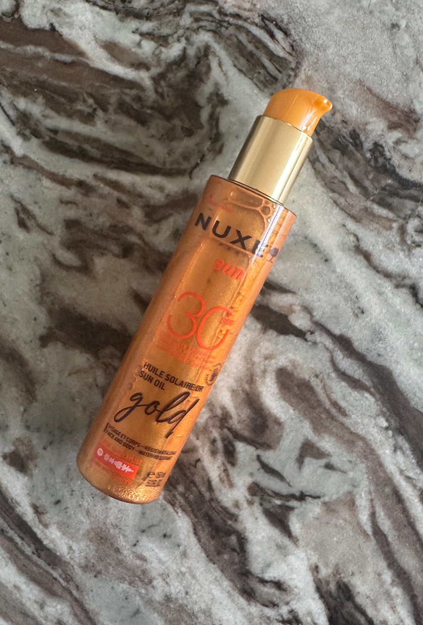 Nuxe Shimmer SPF 30 on marble table