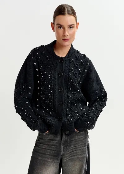 Model in black embellished cardigan