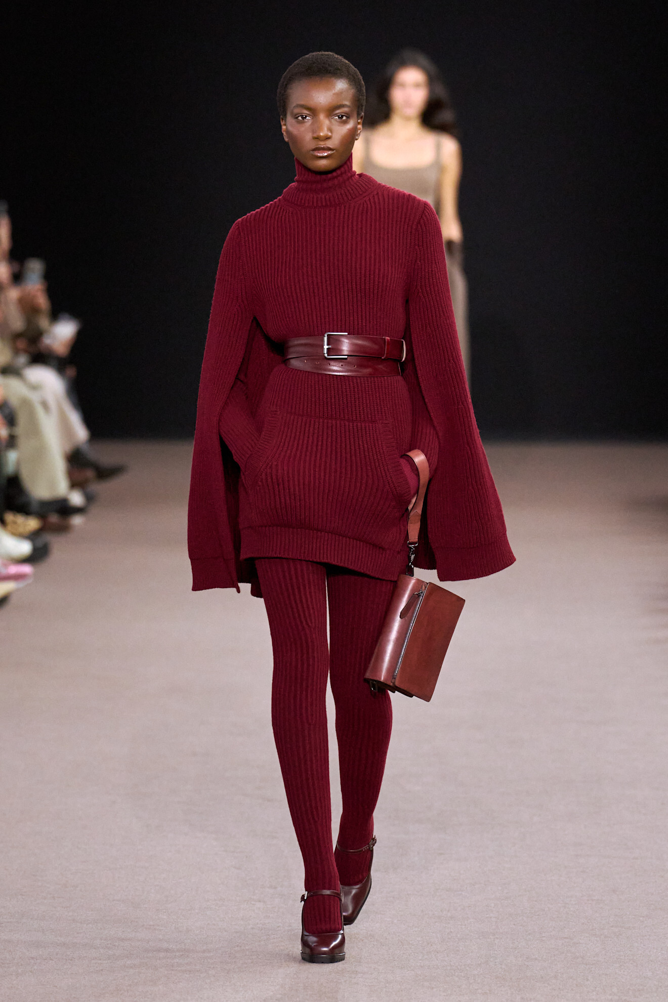 Model on a runway wearing knitwear
