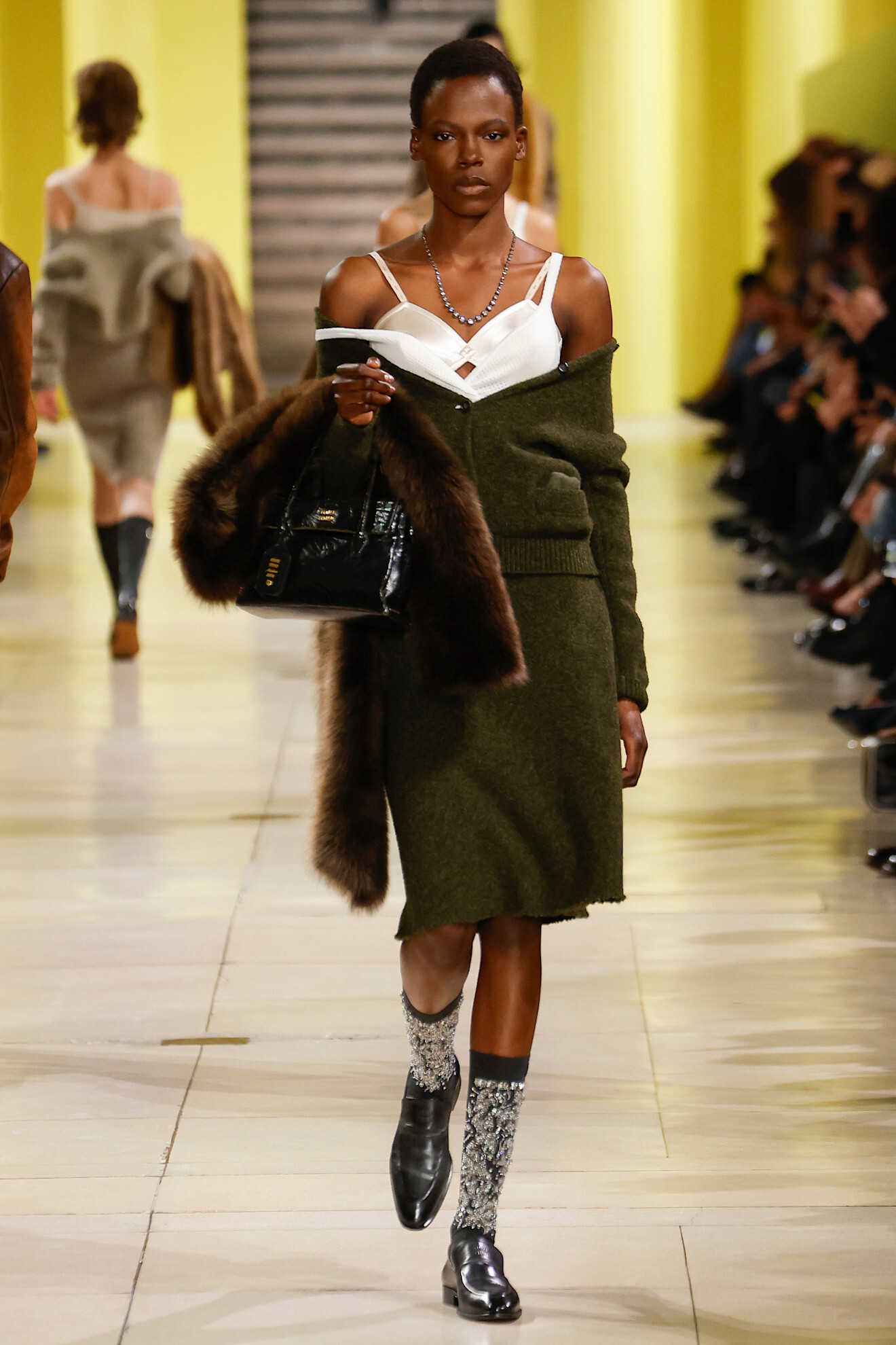 Model on a runway wearing knitwear