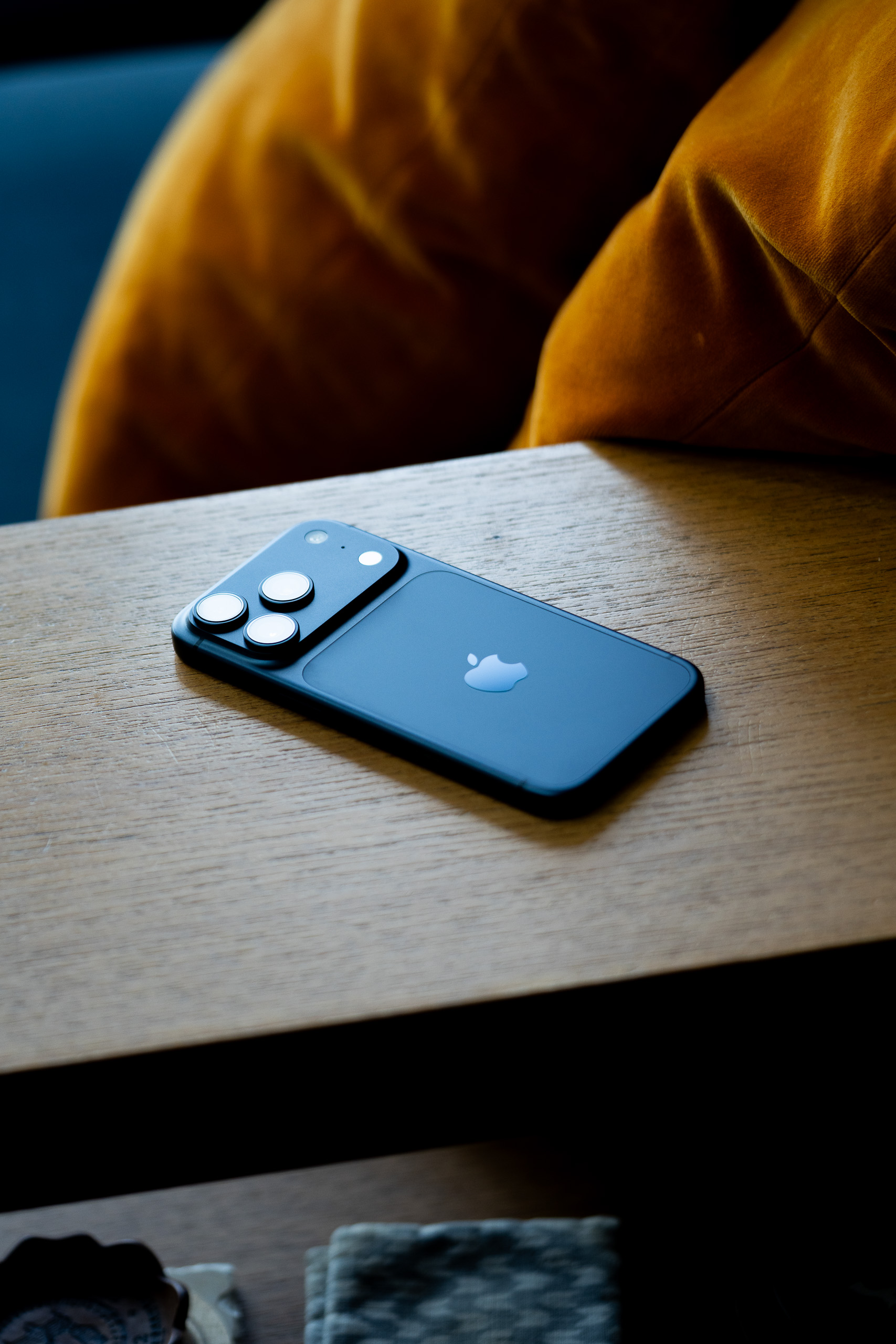 A navy blue iPhone on a wooden background