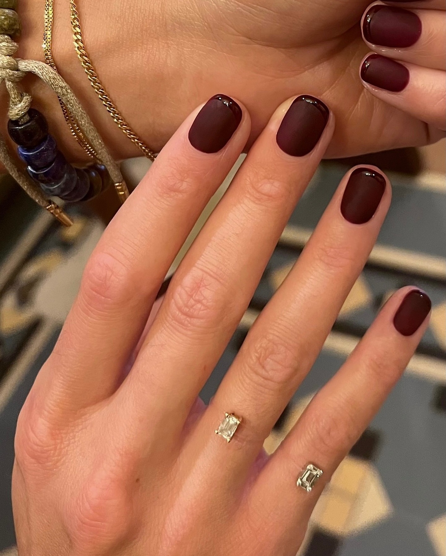 A matte burgundy manicure with burgundy glossy French tips