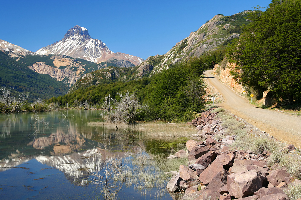A car moves along a dirt track i. Patagonia on the Carretera Austral