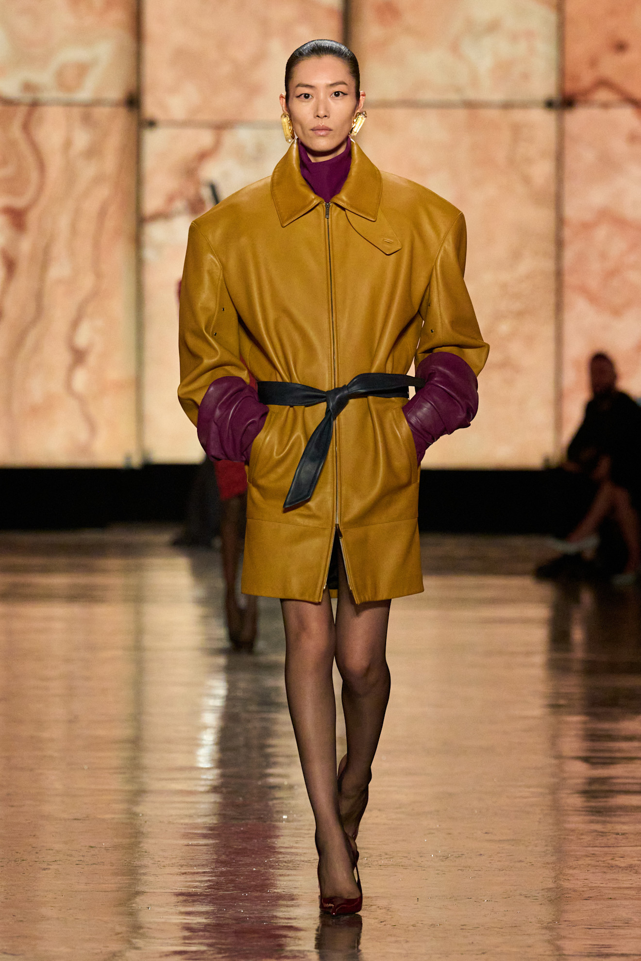 Model wears the butter and burgundy colour combination on the Saint Laurent runway.
