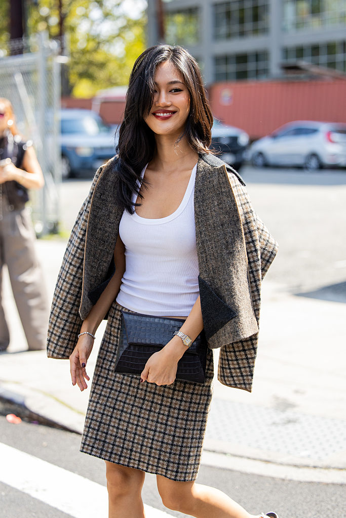 Jihoon Kim wearing the cos check skirt and cos check jacket with a white tank top.