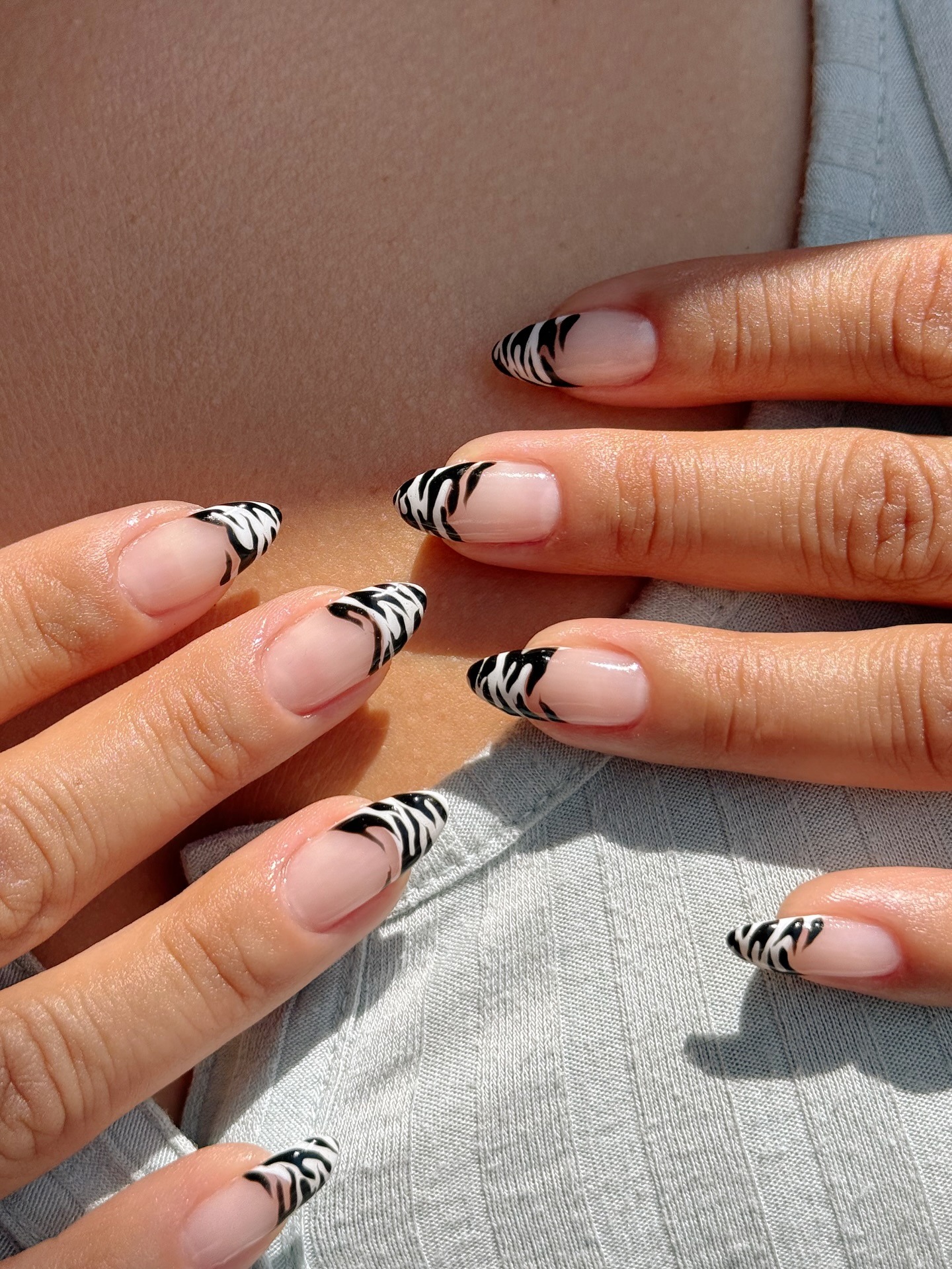 A zebra print French tip manicure