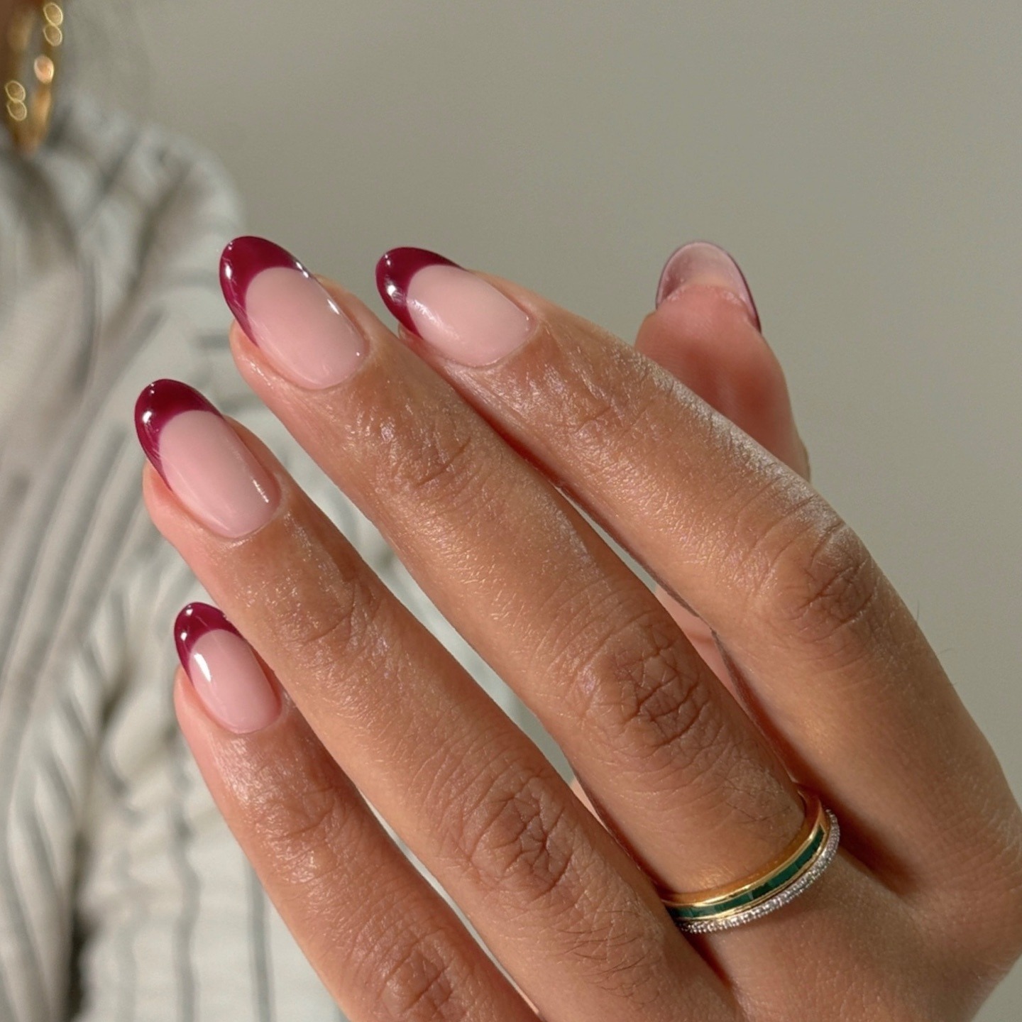 An almond-shaped, burgundy French tip manicure