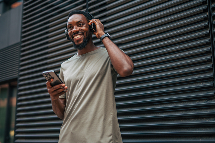 Young man listening to music on his phone with headphones