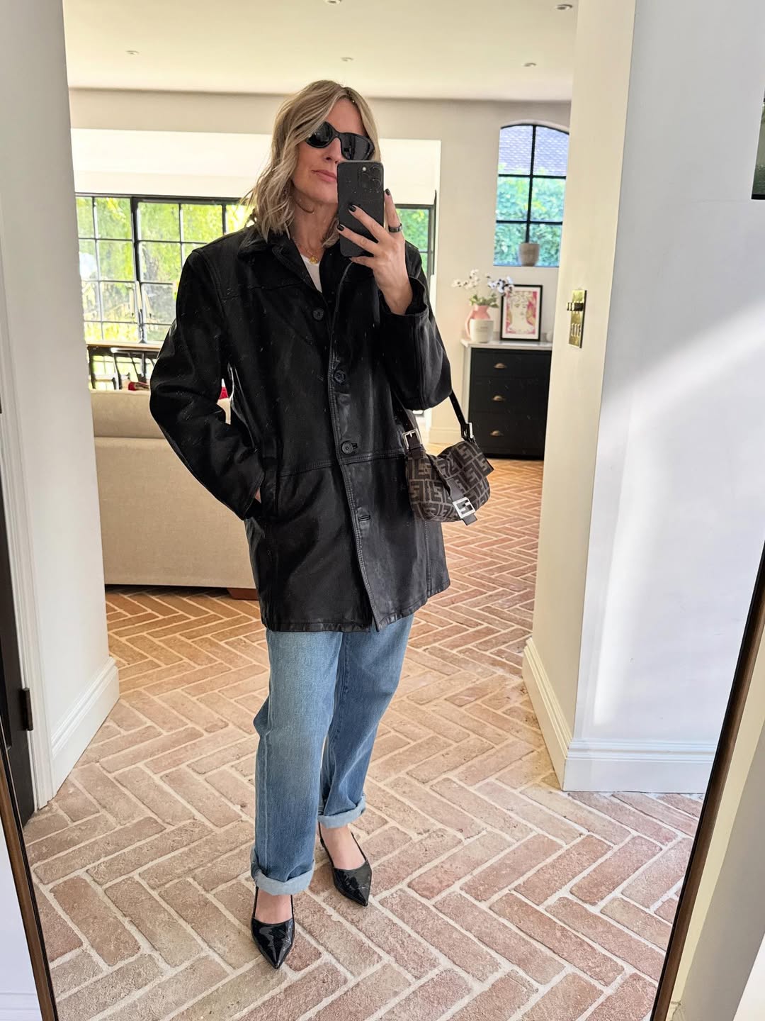 Emma Rose Thatcher wearing an H&amp;amp;M jacket and blue jeans.