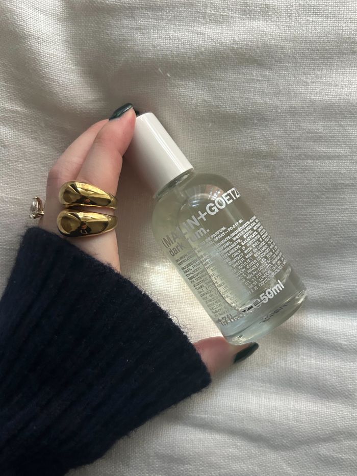 Junior beauty editor Grace Lindsay holding a Malin+Goetz perfume