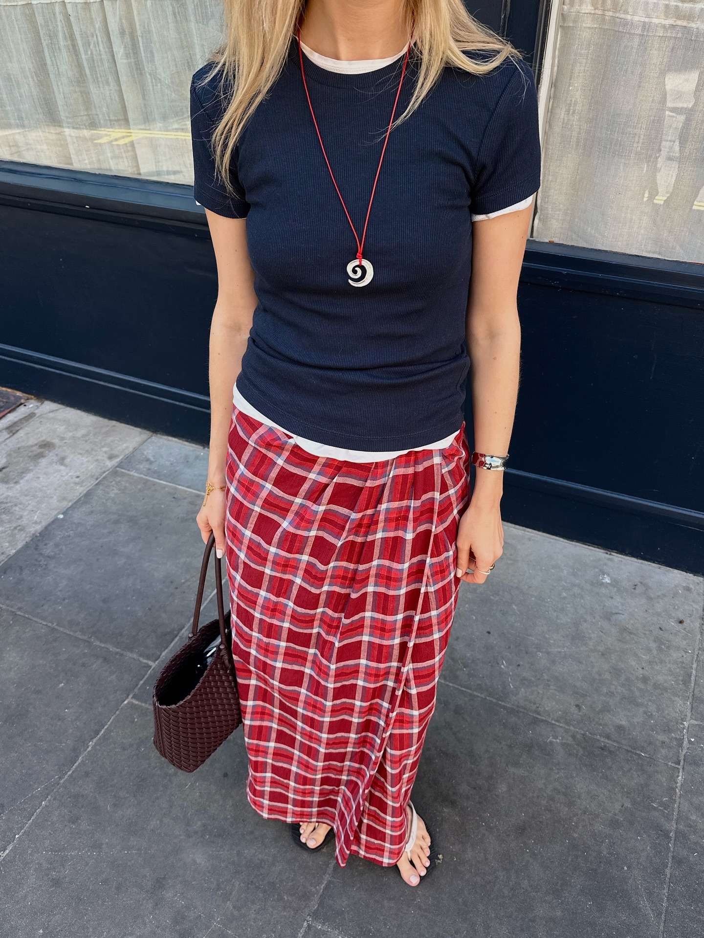 Influencer @chloekathbutler wears a red checked skirt.