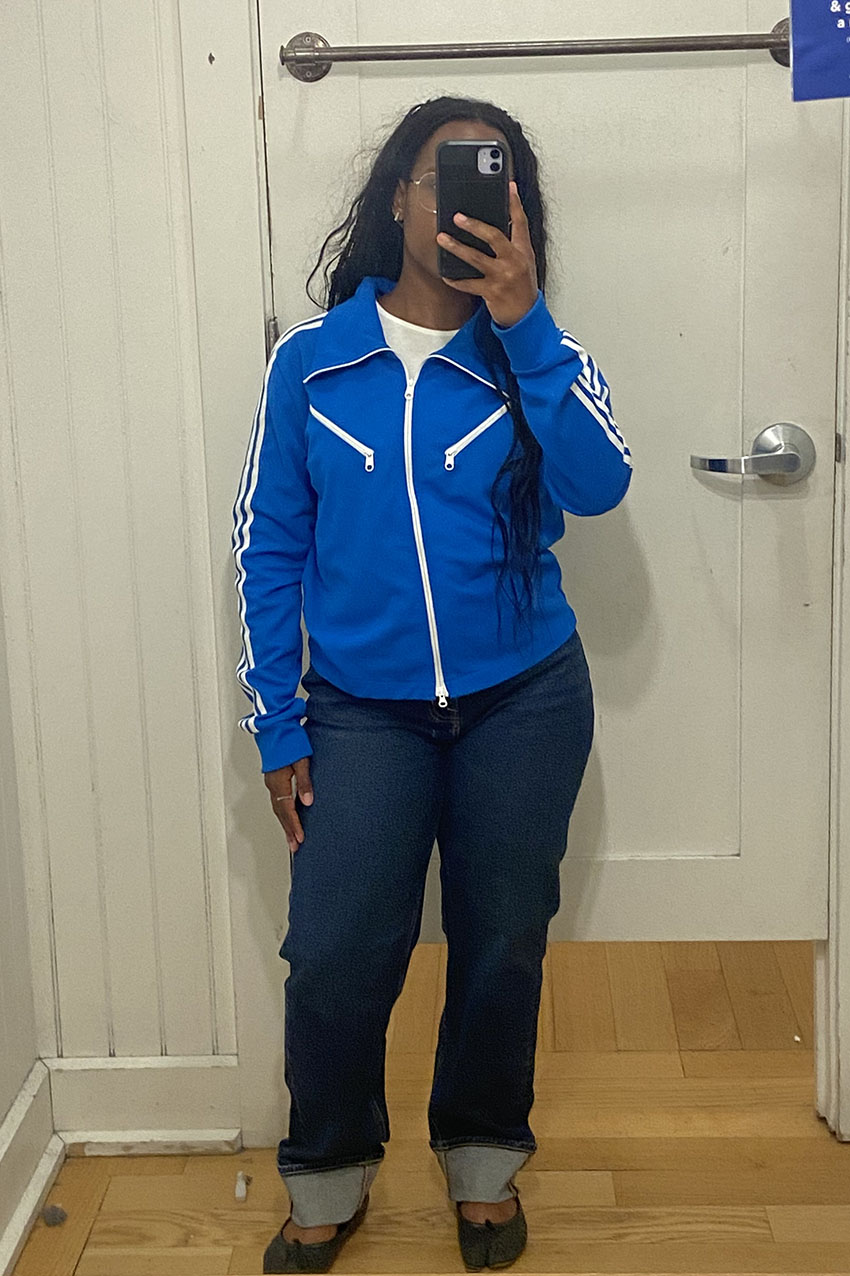 A woman wearing a blue jacket and straight-leg jeans