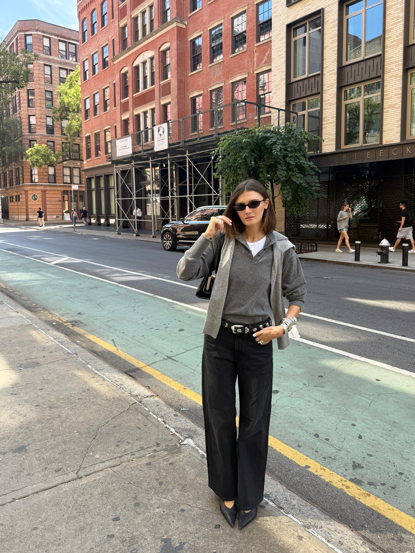 Coco Schiffer wearing a sweater draped over her shoulders and a collared sweater